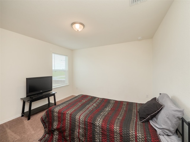 carpeted bedroom with visible vents and baseboards