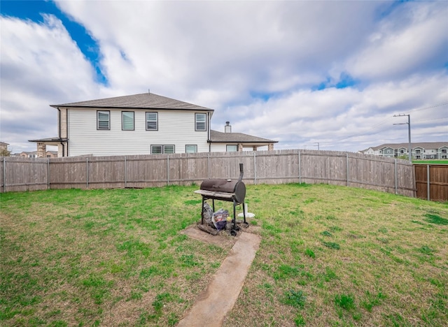 view of yard with a fenced backyard