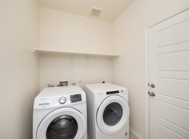 laundry room featuring laundry area, independent washer and dryer, baseboards, and visible vents