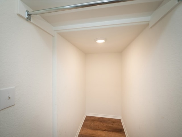 interior space featuring baseboards and wood finished floors