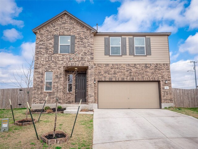 201 Teller Dr, Lockhart, TX 78644 - traditional-style house featuring brick siding, an attached garage, and driveway