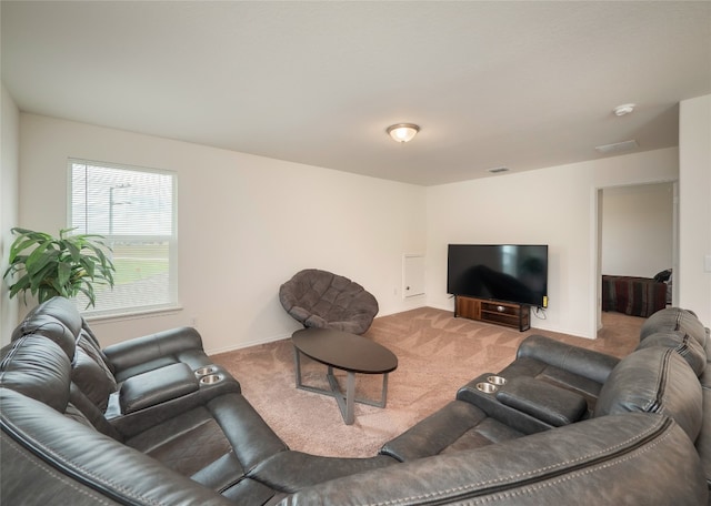 carpeted living room featuring baseboards and visible vents