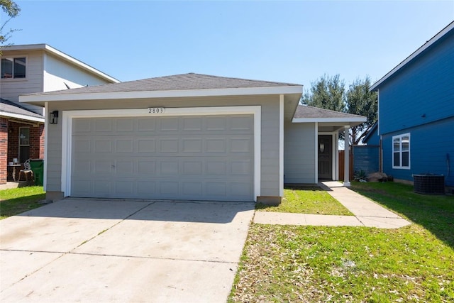 view of front facade featuring driveway, a front lawn, roof with shingles, and an attached garage