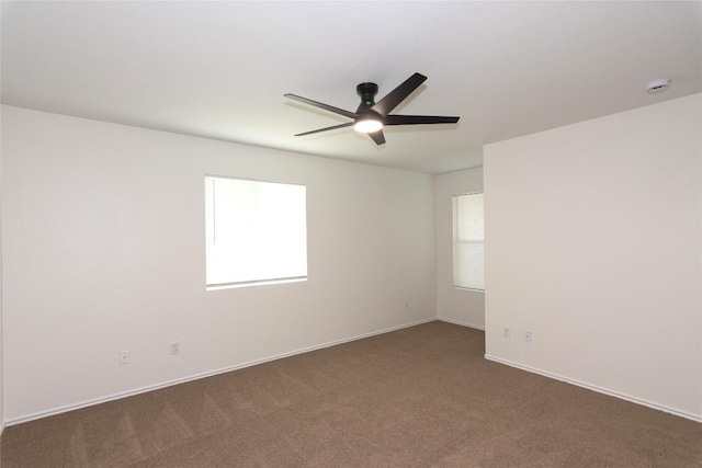 unfurnished room featuring baseboards, ceiling fan, and carpet flooring