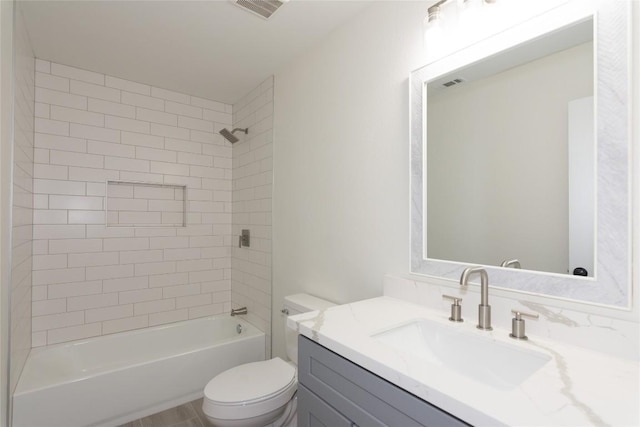 full bathroom featuring visible vents, toilet, vanity, and shower / tub combination