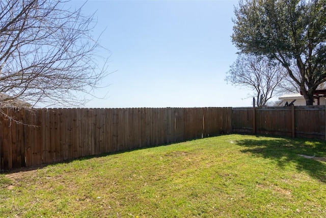 view of yard with a fenced backyard