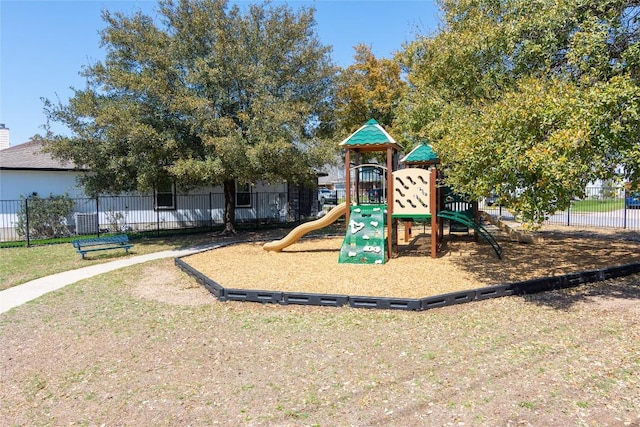 community play area with fence and a lawn