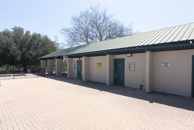 exterior space with fence and metal roof