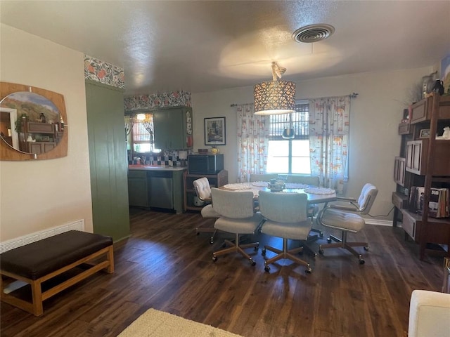 dining space featuring wood finished floors and visible vents