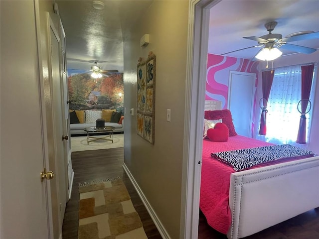 hall with wood finished floors and baseboards