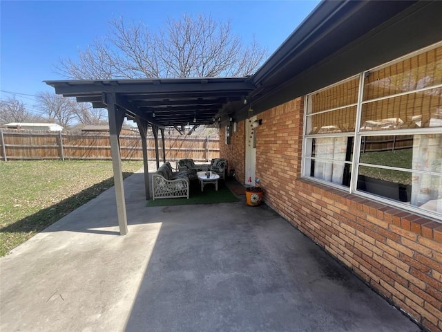 view of patio / terrace with an attached carport and fence