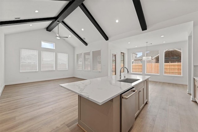 kitchen with beamed ceiling, a center island with sink, a ceiling fan, a sink, and stainless steel dishwasher