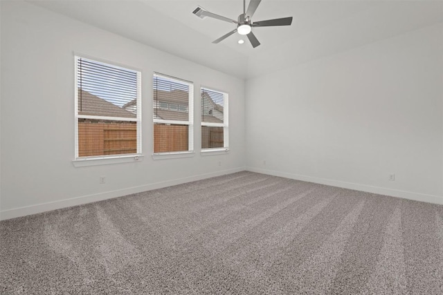 carpeted spare room featuring visible vents, baseboards, and a ceiling fan