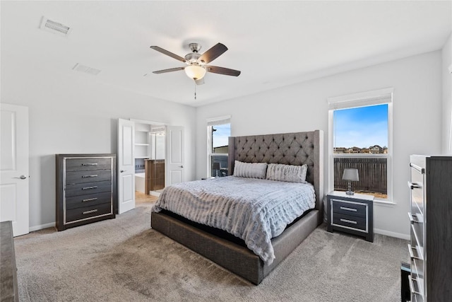 bedroom featuring multiple windows, light colored carpet, and visible vents