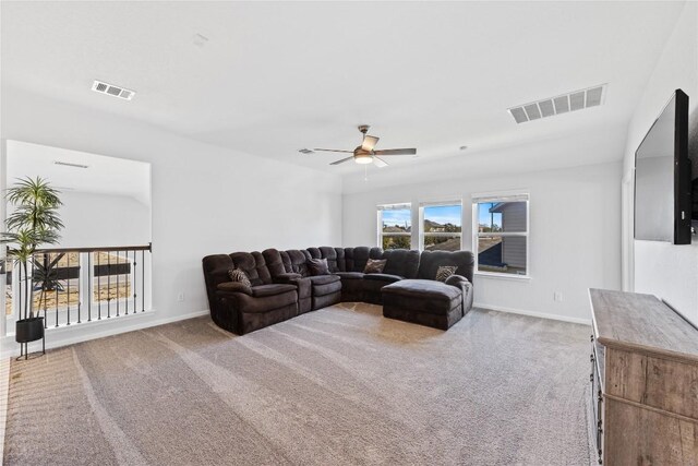 living area with visible vents, baseboards, ceiling fan, and carpet flooring