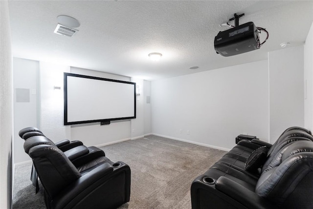 carpeted cinema featuring visible vents, a textured ceiling, and baseboards