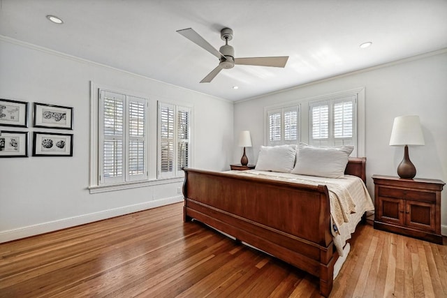 bedroom featuring hardwood / wood-style flooring, recessed lighting, crown molding, baseboards, and ceiling fan