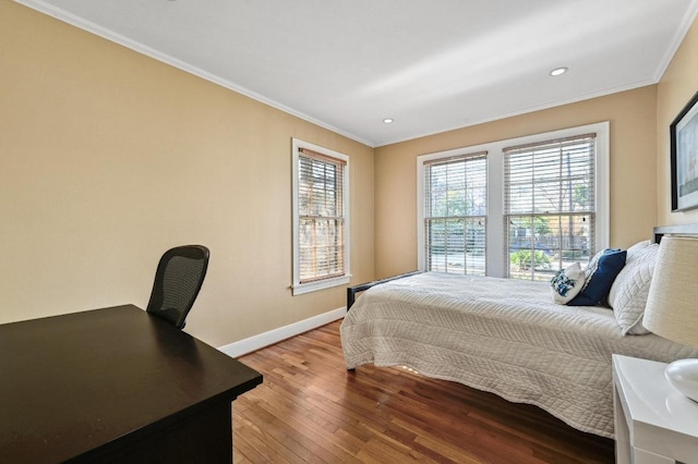 bedroom featuring hardwood / wood-style flooring, recessed lighting, baseboards, and ornamental molding