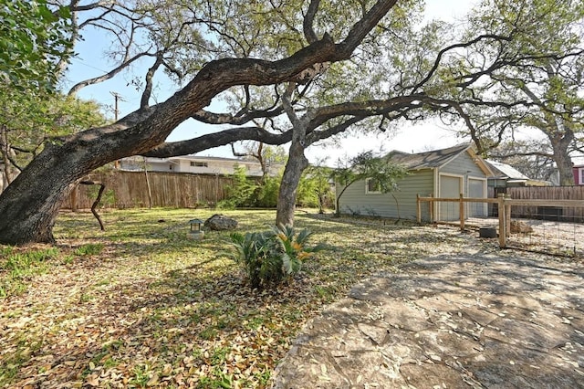 view of yard featuring a garage and fence