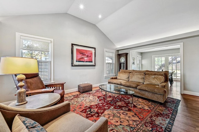 living room with lofted ceiling, wood finished floors, baseboards, and french doors