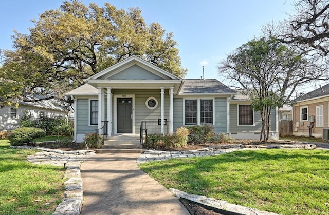 bungalow-style home featuring a front lawn and cooling unit