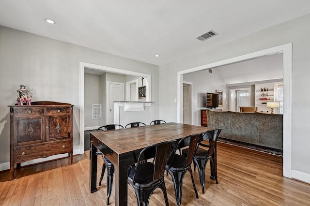 dining area featuring light wood-style flooring, recessed lighting, baseboards, and visible vents