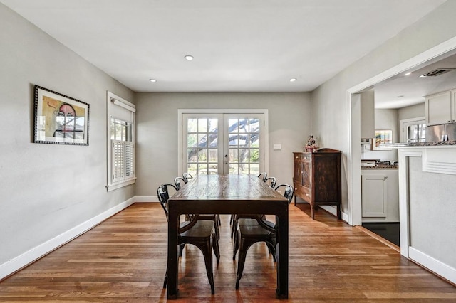 dining space with visible vents, wood finished floors, recessed lighting, french doors, and baseboards