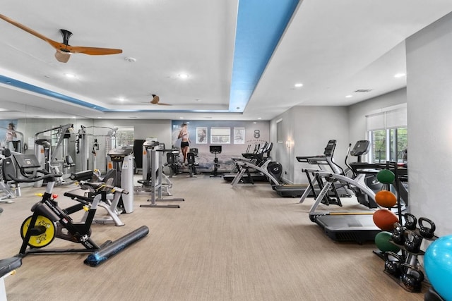 workout area featuring visible vents, a tray ceiling, carpet floors, recessed lighting, and a ceiling fan