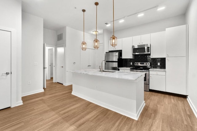 kitchen featuring a sink, light wood-type flooring, visible vents, and stainless steel appliances