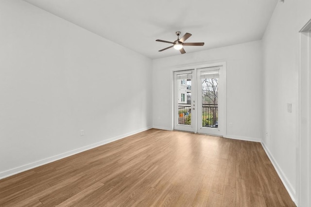 unfurnished room featuring baseboards, ceiling fan, and wood finished floors