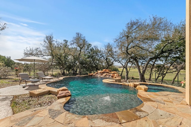 view of pool featuring a patio area, a fenced in pool, and a fenced backyard