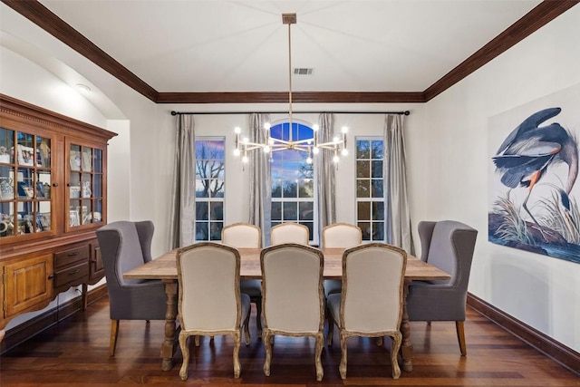 dining room featuring visible vents, baseboards, a chandelier, dark wood finished floors, and ornamental molding