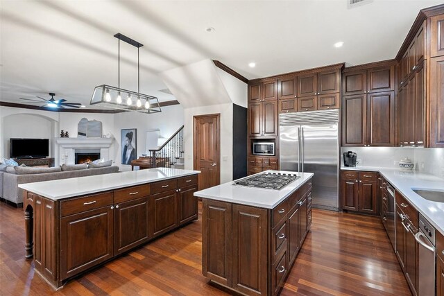 12027 Pleasant Panorama Vw, Austin, TX 78738 - kitchen with built in appliances, a kitchen island, dark wood-type flooring, and recessed lighting