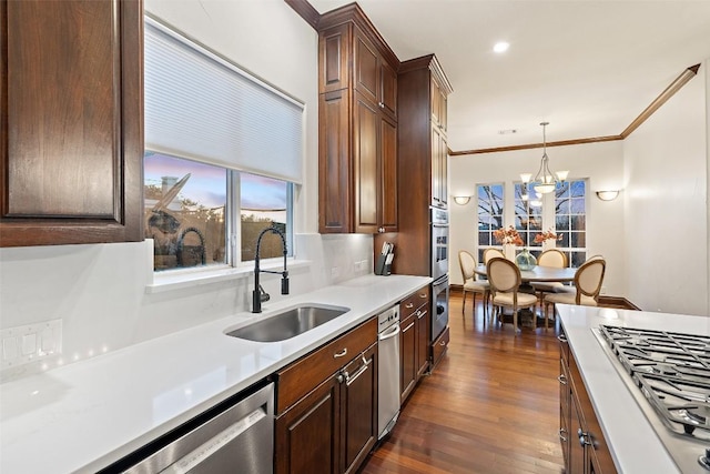12027 Pleasant Panorama Vw, Austin, TX 78738 - kitchen with appliances with stainless steel finishes, pendant lighting, a chandelier, dark wood-style floors, and light countertops