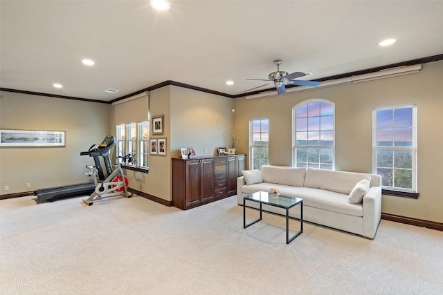 living area with recessed lighting, baseboards, light carpet, and a healthy amount of sunlight