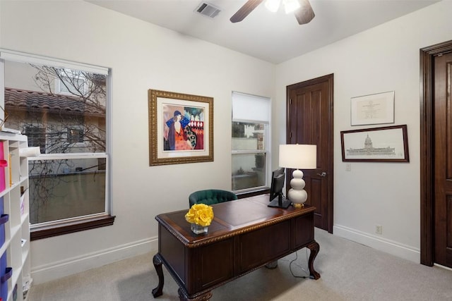 home office with visible vents, carpet floors, baseboards, and a ceiling fan