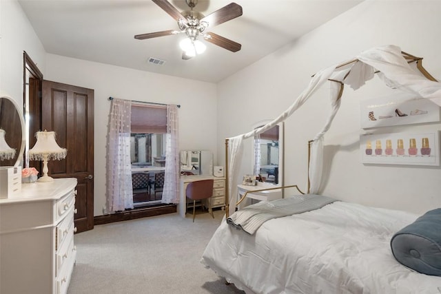 bedroom featuring visible vents, light carpet, and a ceiling fan