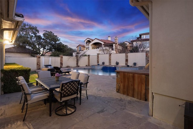 view of patio / terrace featuring outdoor dining area, a fenced in pool, and a fenced backyard