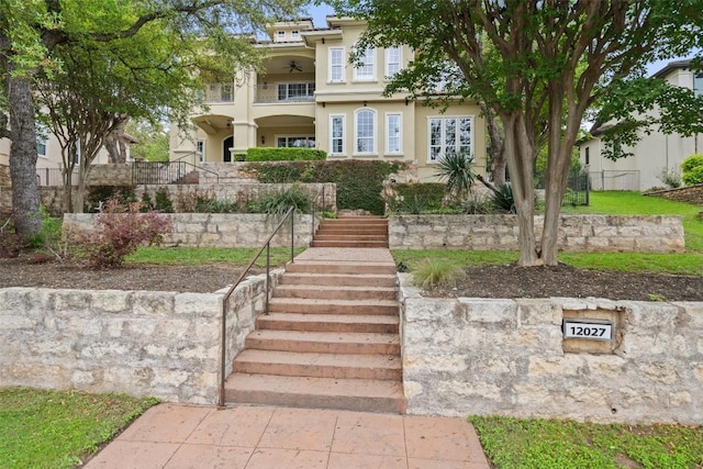 12027 Pleasant Panorama Vw, Austin, TX 78738 - view of front of property featuring stairway, a balcony, stucco siding, and ceiling fan