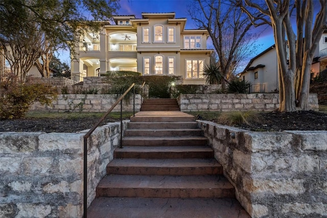 12027 Pleasant Panorama Vw, Austin, TX 78738 - view of front facade with stairway, stucco siding, and a balcony