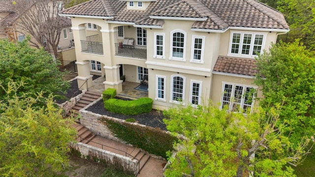 12027 Pleasant Panorama Vw, Austin, TX 78738 - back of house with a balcony, a tile roof, and stucco siding