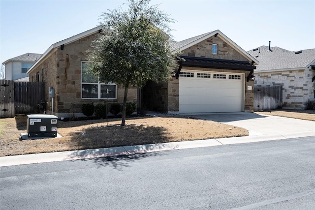 view of front of house featuring fence, driveway, a standing seam roof, stone siding, and metal roof