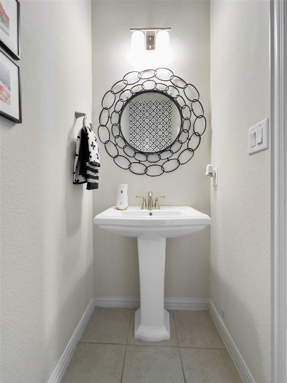 bathroom featuring tile patterned flooring and baseboards