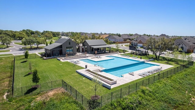 community pool featuring a yard, a patio area, and fence