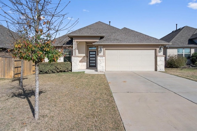 view of front of house with driveway, stone siding, fence, roof with shingles, and a garage