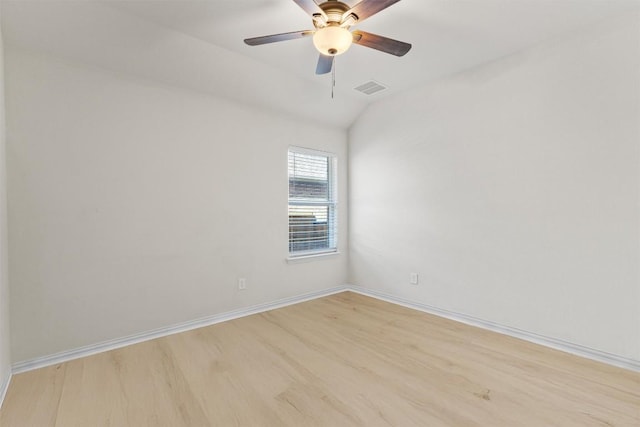 spare room with visible vents, ceiling fan, baseboards, light wood-type flooring, and lofted ceiling