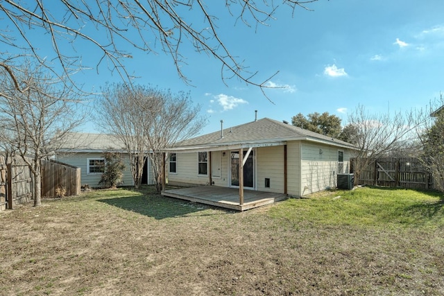 rear view of house with a wooden deck, cooling unit, a lawn, and a fenced backyard