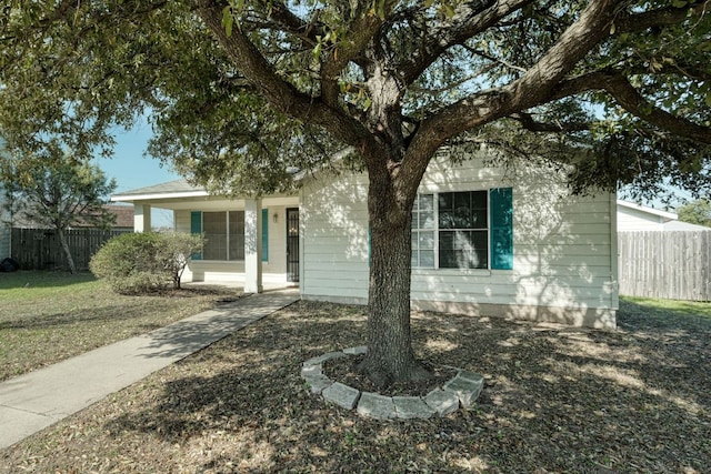 single story home featuring fence