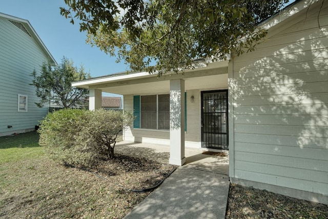 view of exterior entry with covered porch