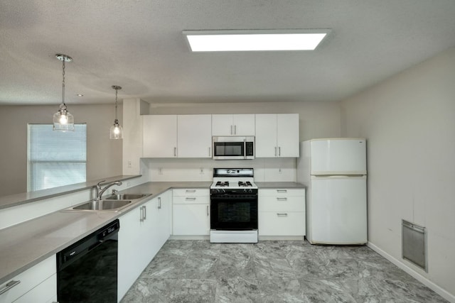 kitchen featuring white appliances, a sink, light countertops, pendant lighting, and white cabinetry